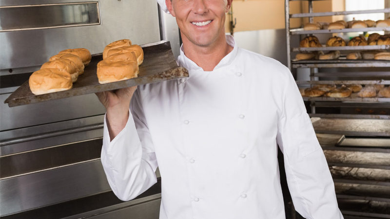 baker-holding-tray-of-fresh-bread